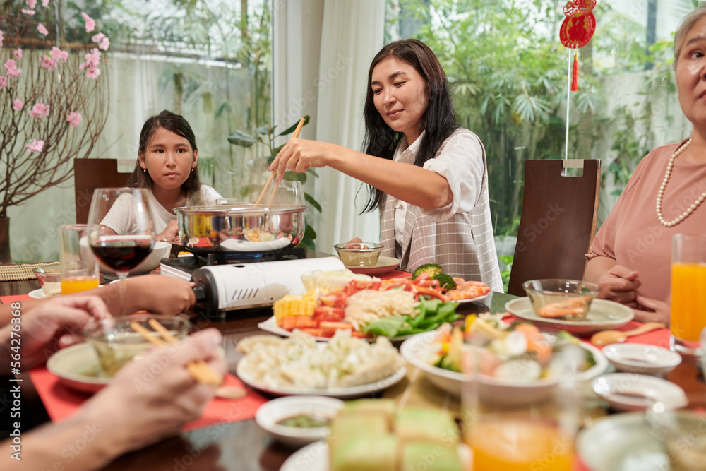 Big family enjoying tasty dishes cooked for spring festival