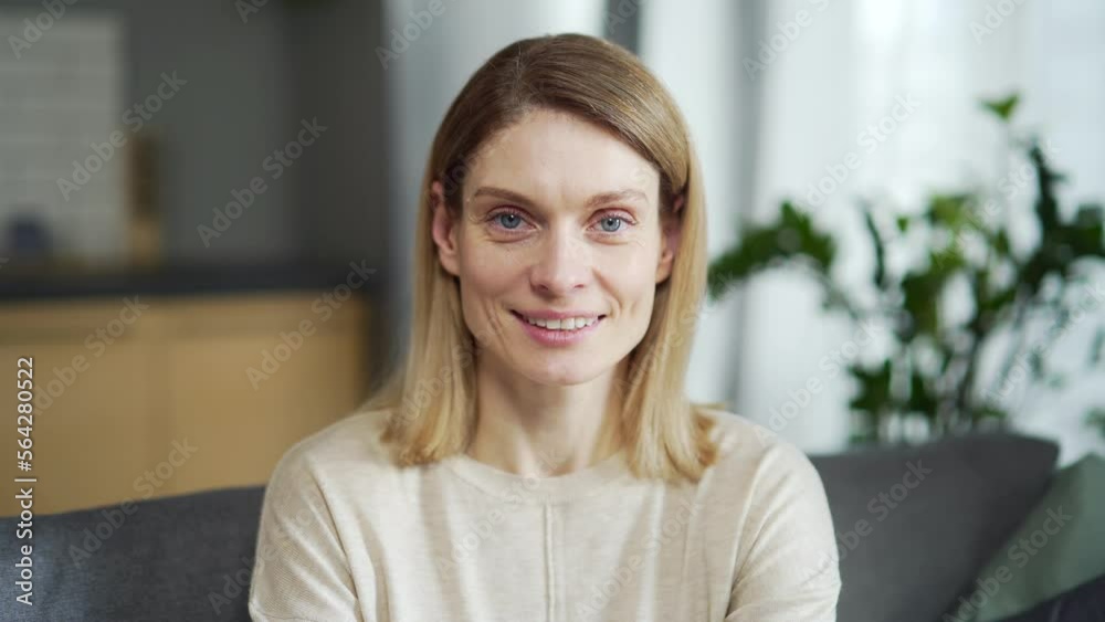 Confident smiling young adult european woman looking at camera standing at home. Happy casual caucasian lady with pretty face posing for close up portrait indoors. turns head with happy emotion Confident smiling young adult european woman looking at camera standing at home. Happy casual caucasian lady with pretty face posing for close up portrait indoors. turns head with happy emotion