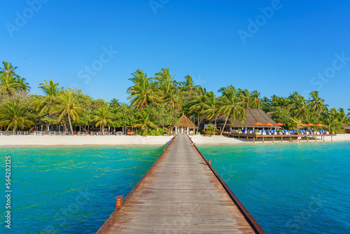 Vacation on a desert island in the tropics and the wooden jetty to the island