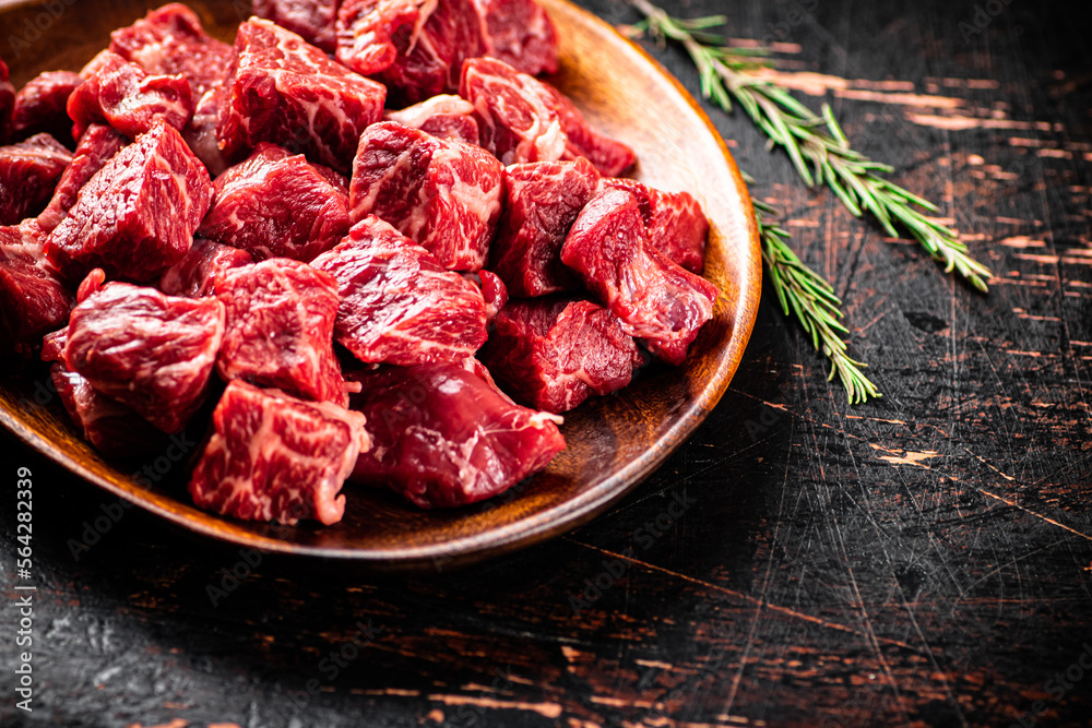 Chunks of fresh raw beef on a plate. Chunks of fresh raw beef on a plate.