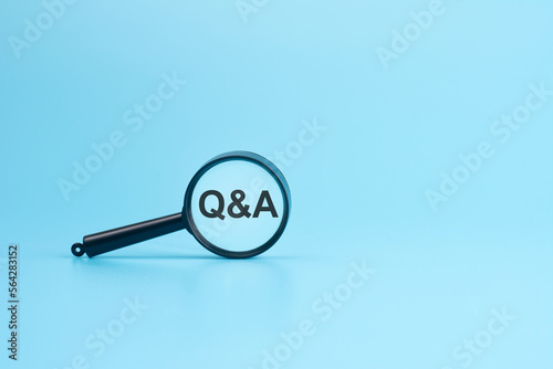 look at the text Q and A through a magnifying glass on a blue background