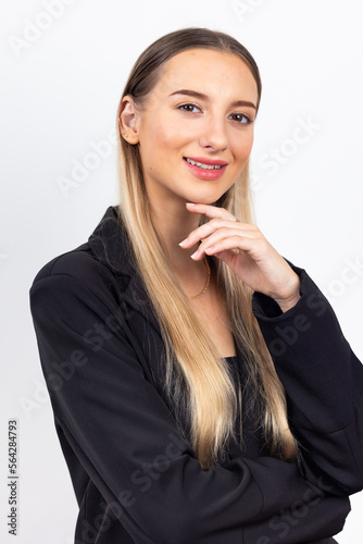 Happy young caucasian female looking at camera. Professional company business woman over white wall background