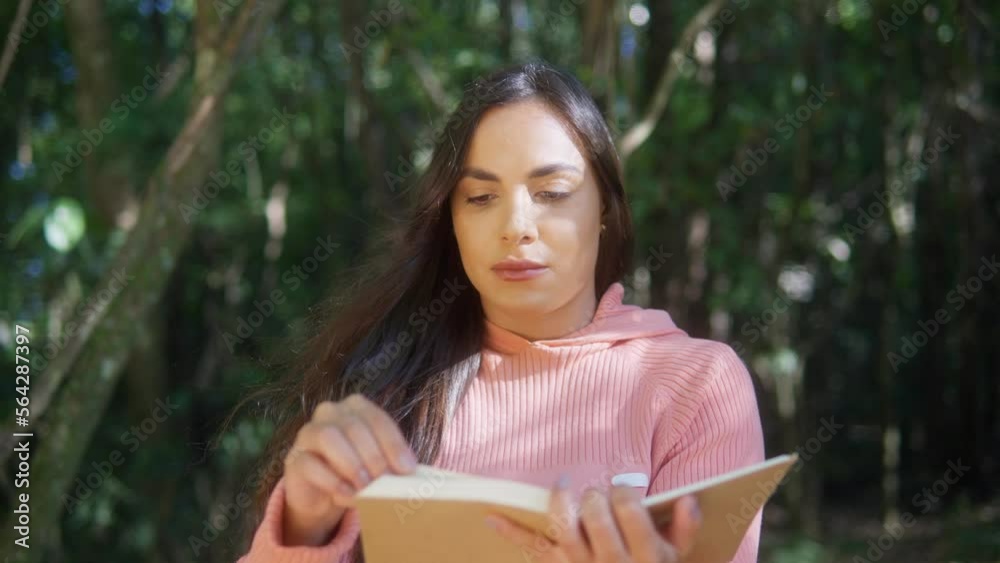 creative enjoy freedom in nature. brazilian woman , reading book in the park.  