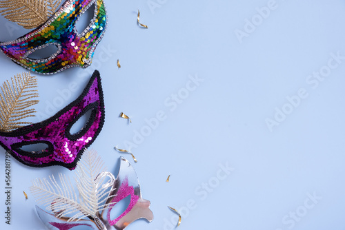 Festive face mask for carnival celebration on colored background. Copy space