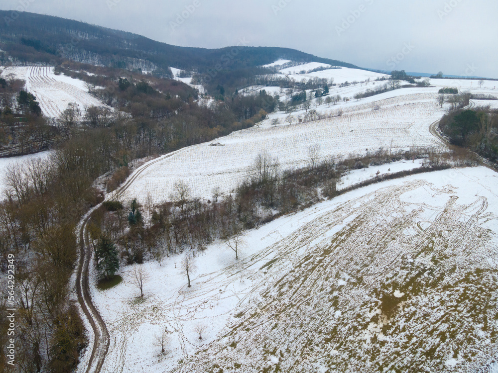 drone flight over landscape with very little snow and you can see the green meadow