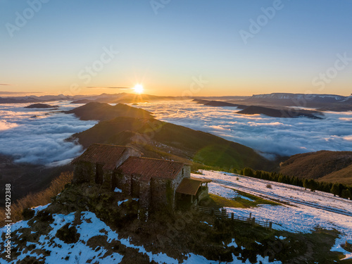 Hermitage in Kolitza mount in Balmaseda at dawn with snow, Basque Country, Spain drone view © David