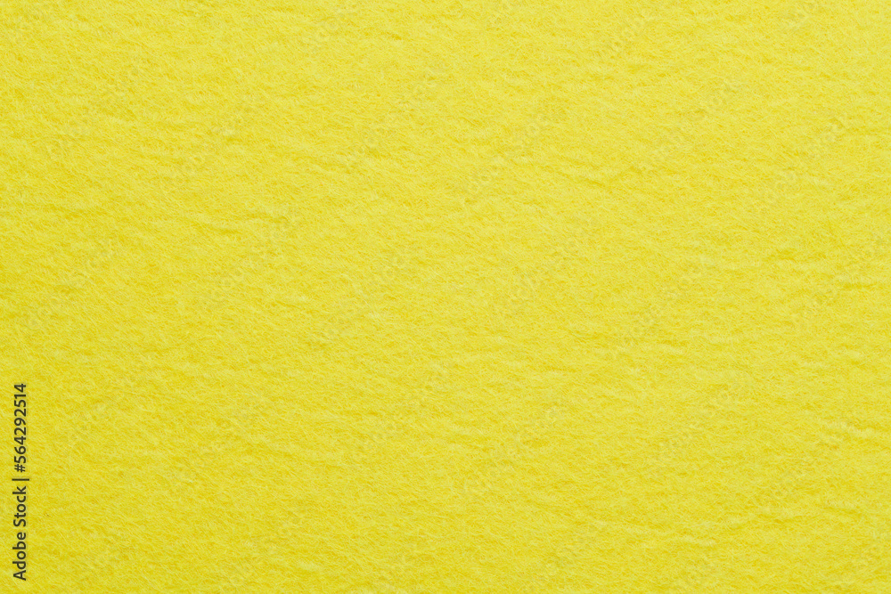 Obraz premium Soft felt textile material yellow color, colorful texture flap fabric background closeup