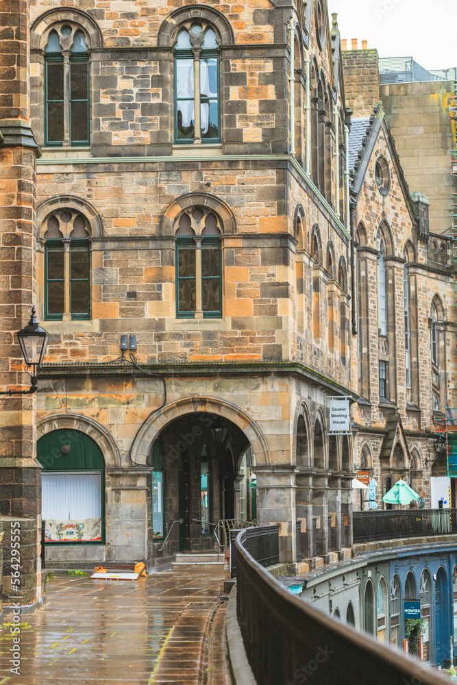 Raindrops on windowpanes, reflections of Edinburgh's historic buildings. Wet streets. colorful umbrellas, a picturesque scene in Edinburgh city center