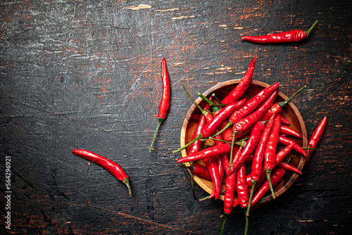 Wooden plate with hot chili peppers. 