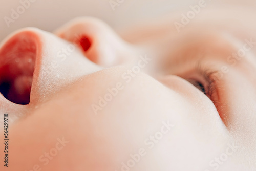 Close-up of a baby's face. Big eyes, lovely nose, mouth. A cute baby