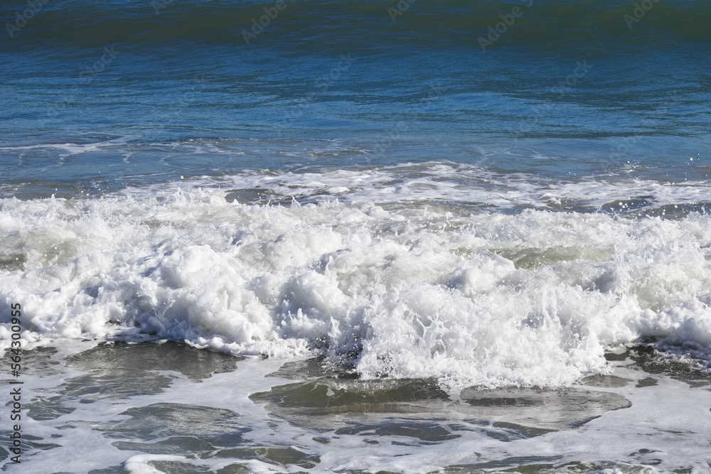 Fototapeta premium Striking scene of waves breaking on the sand of a Spanish beach