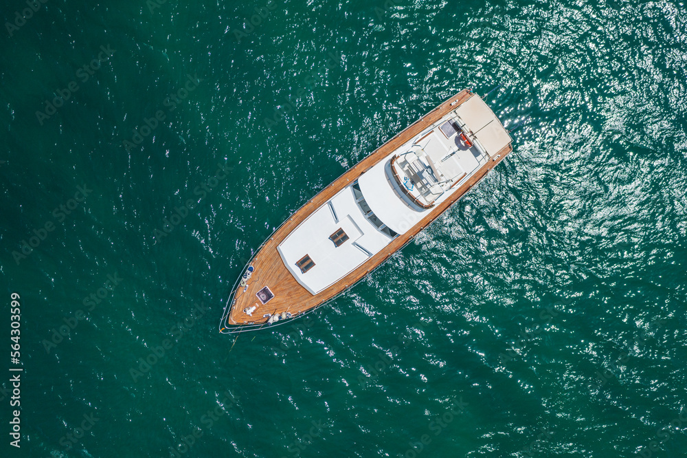 Above view at exclusive yacht docked on crystal water.