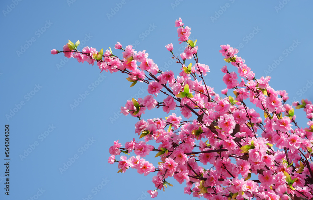 artificial peach blossoms on a branch