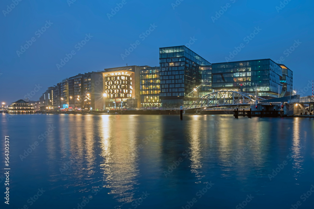Modern buildings in the harbor from Amsterdam in the Netherlands at night Modern buildings in the harbor from Amsterdam in the Netherlands at night