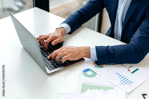 Close-up image of male hands typing on a laptop computer keyboard, searching information, browsing internet, online working. Business man chatting online, responds by email