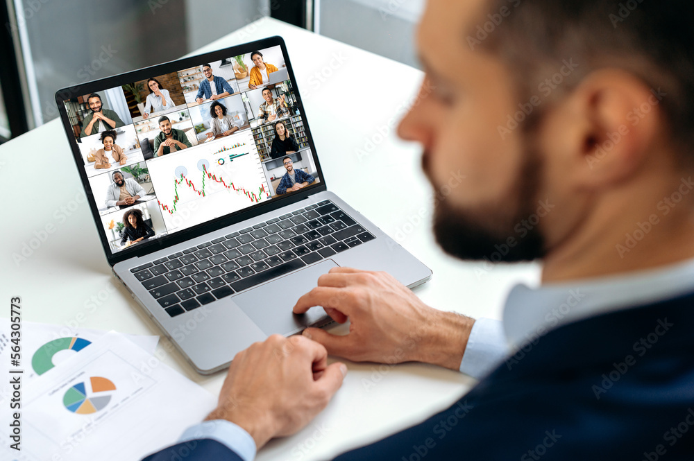 © Kateryna - Online video conference. Caucasian successful business man, financial director, talking on video link with his colleagues, discussing financial strategy, analyzing charts, planning development