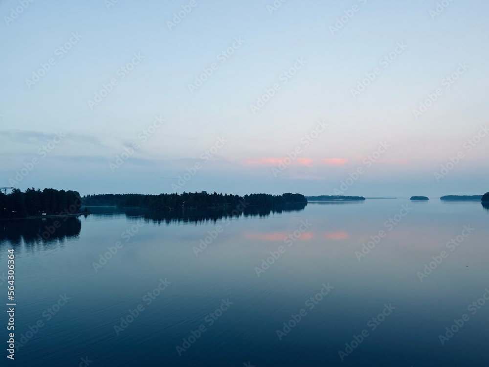 Tender fog at the lake, bright blue and purple sky, natural misty lake background