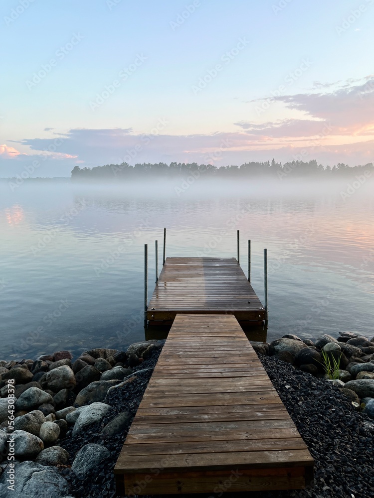 Fototapeta premium Tender fog at the lake, bright blue and purple sky, natural misty lake background