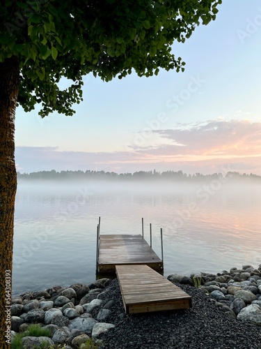 Fototapeta Naklejka Na Ścianę i Meble -  Tender fog at the lake, bright blue and purple sky, natural misty lake background