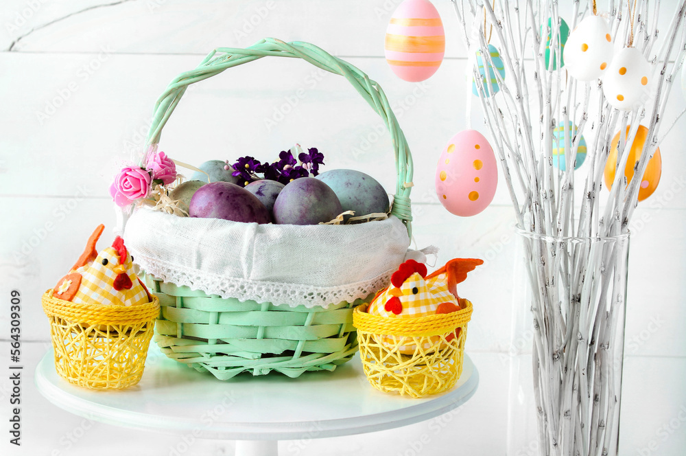 Easter eggs in a wicker basket on a white background. Decorative chicken with eggs. Easter tree. Easter composition with space for text Easter eggs in a wicker basket on a white background. Decorative chicken with eggs. Easter tree. Easter composition with space for text