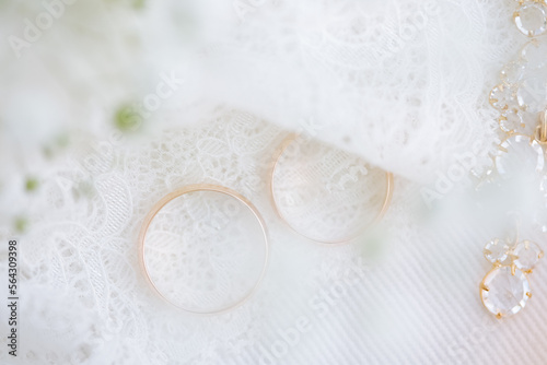 Golden wedding rings on lace fabric