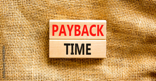 Payback time symbol. Concept words Payback time on wooden blocks. Beautiful canvas table canvas background. Business and payback time concept. Copy space. photo