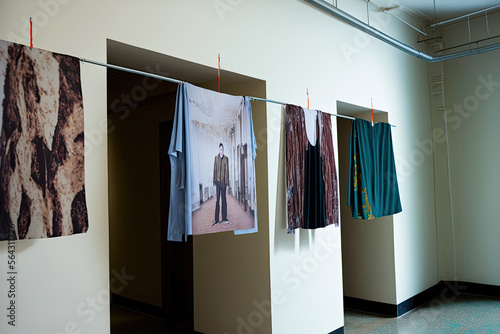 clothes hanging on a clothesline in a room. Generative AI © jr-art