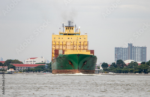 The Vessel Type Container Ship sails from the Chao Phraya River, Thailand photo