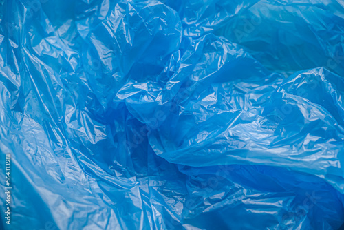 Texture and background of a blue plastic bag. Blue disposable plastic bag. Environmental problems, recycling, waste. photo