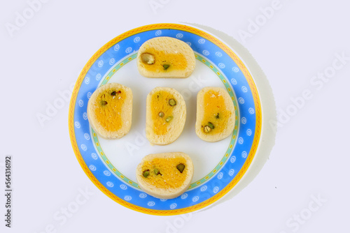 Delicious Indian yellow Sweets on a plate photo