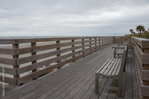 empty benches on an ocean side boardwalk
