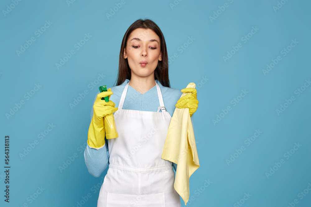 woman in cleaner apron with cleaning rag and detergent sprayer woman in cleaner apron with cleaning rag and detergent sprayer