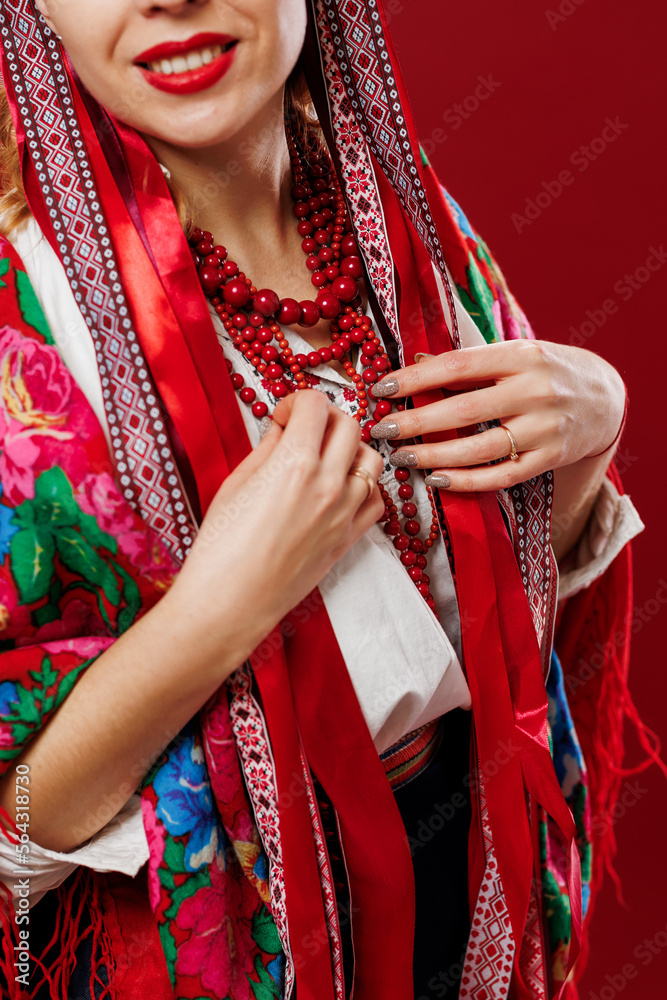 Close up of ukrainian woman in traditional ethnic clothing on viva magenta studio background. Ukrainian national embroidered dress call vyshyvanka. Pray for Ukraine