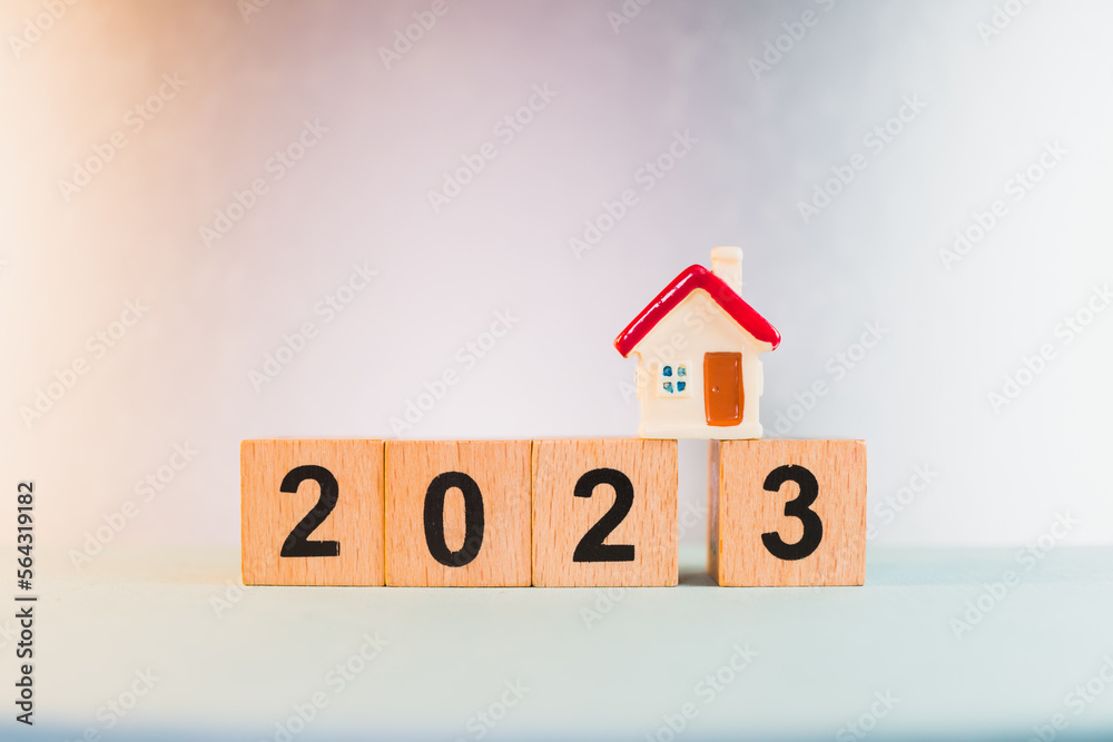 Miniature house on wooden block year 2023 using as business and property real estate concept Miniature house on wooden block year 2023 using as business and property real estate concept