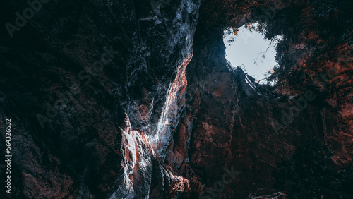 Sun Beams Shine Down Through Cave Ceiling 