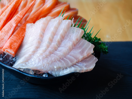 Sashimi set, Tai, Suzuki, Sea Bass, Snapper and Imitation Crab Stick on dish in traditional Japanese food style.