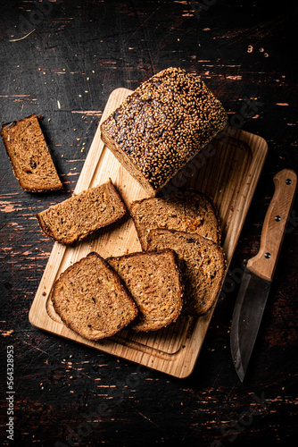 Slices of fresh bread on a wooden cutting board. 