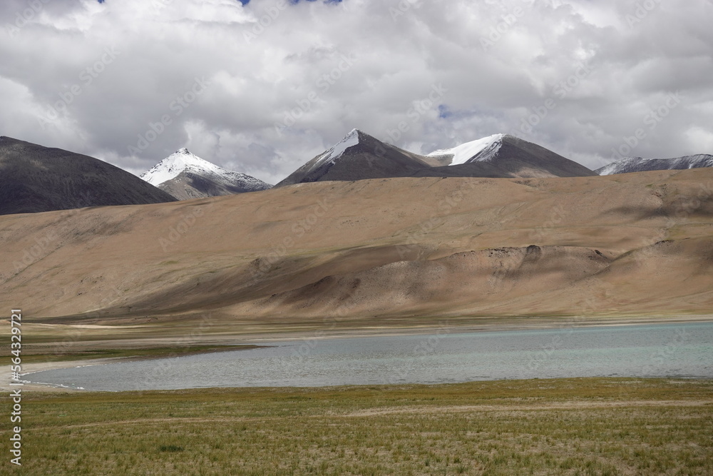 Ladakh, India - August 24th, 2022: SUV Car 4x4 In Mountains ove a Beautiful Lake in Ladakh, Tso Moriri