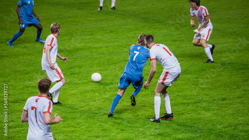 Soccer Football Match Event on a Major League Championship: Blue Team Attacks, Playing Pass, Dribbling. Action Game Tournament. Live Sport Channel Broadcast Television. © Gorodenkoff