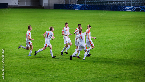 Soccer Football Championship Final Match: White Team Players Happy and Celebrate Victory, Hug after Winning Major League Sport Event. Television Broadcast Channel Concept.