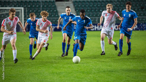 Professional Soccer Football Match Championship  Blue Team Attacks  Black Forward Masterfully Dribbles on an International Tournament. Television Channel Broadcast Concept.