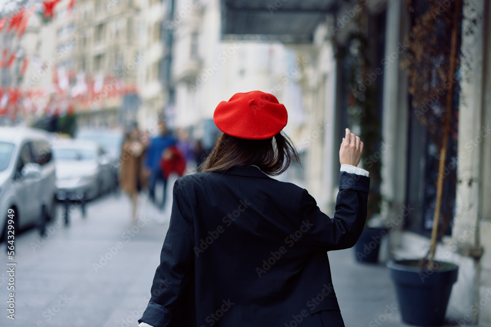 Woman happiness view from the back, follow me walks walks in the city against the backdrop of office buildings, stylish fashionable vintage clothes and makeup, spring walk, travel. Woman happiness view from the back, follow me walks walks in the city against the backdrop of office buildings, stylish fashionable vintage clothes and makeup, spring walk, travel.