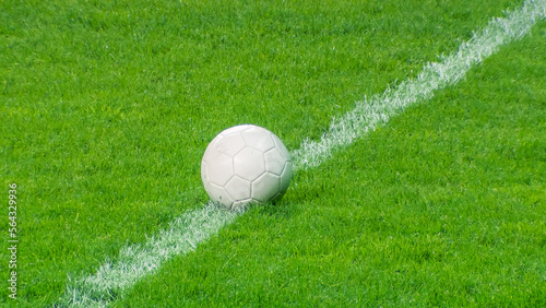 Close-up of a Football Ball. Conceptual Shot Representing the Start of the Game, Success, Victory, Determination in Sport and Life. Low Angle Ground Artistic Shot. Establishing Shot © Gorodenkoff