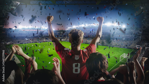 Establishing Shot of Fans Cheer for Their Team on a Stadium During Soccer Championship Match. Team Scores Goal, Crowds of Fans Scream, Celebrate Victory with Confetti. Football Cup Tournament.