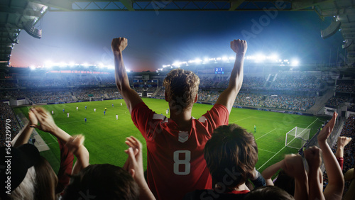 Establishing Shot of Fans Cheer for Their Team on a Stadium During Soccer Championship Match. Teams Play, Crowds of Fans Scream, Celebrate Victory, Goal. Football Cup Tournament. Wide Shot