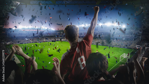 Establishing Shot of Fans Cheer for Their Team on a Stadium During Soccer Championship Match. Team Scores Goal, Crowds of Fans Scream, Celebrate Victory with Confetti. Football Cup Tournament Concept.