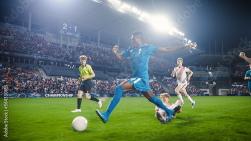 Professional Soccer Football Match Championship: Blue Team Attacks, Black Forward Masterfully Dribbles on an International Tournament. Stadium of Fans Cheers. Beautiful Cinematic Edit. © Gorodenkoff