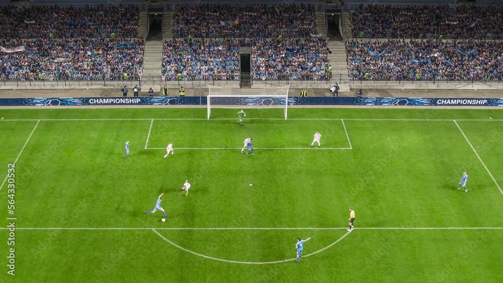 Fototapeta premium Football Championship Stadium with Crowd of Fans: Blue Team Player Receives Successful Pass and Attacks The Goals. International Sports Television Broadcast. High Angle Wide Shot.