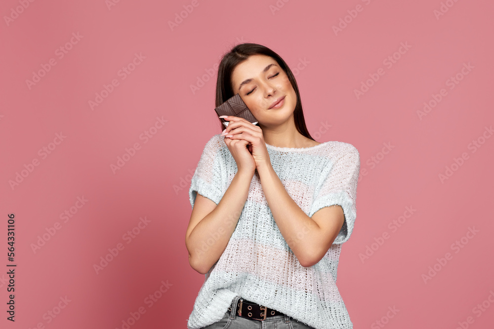 lovely smiling dreamy woman enjoying dark chocolate lovely smiling dreamy woman enjoying dark chocolate