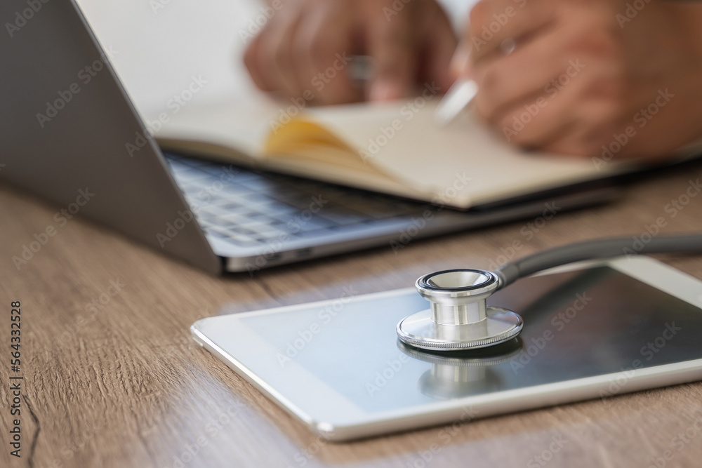 Medical healthcare network on Computing electronic medical record. Doctor working an Laptop with Stethoscope Medical healthcare network on Computing electronic medical record. Doctor working an Laptop with Stethoscope